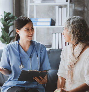 a happy caregiver talking to elderly