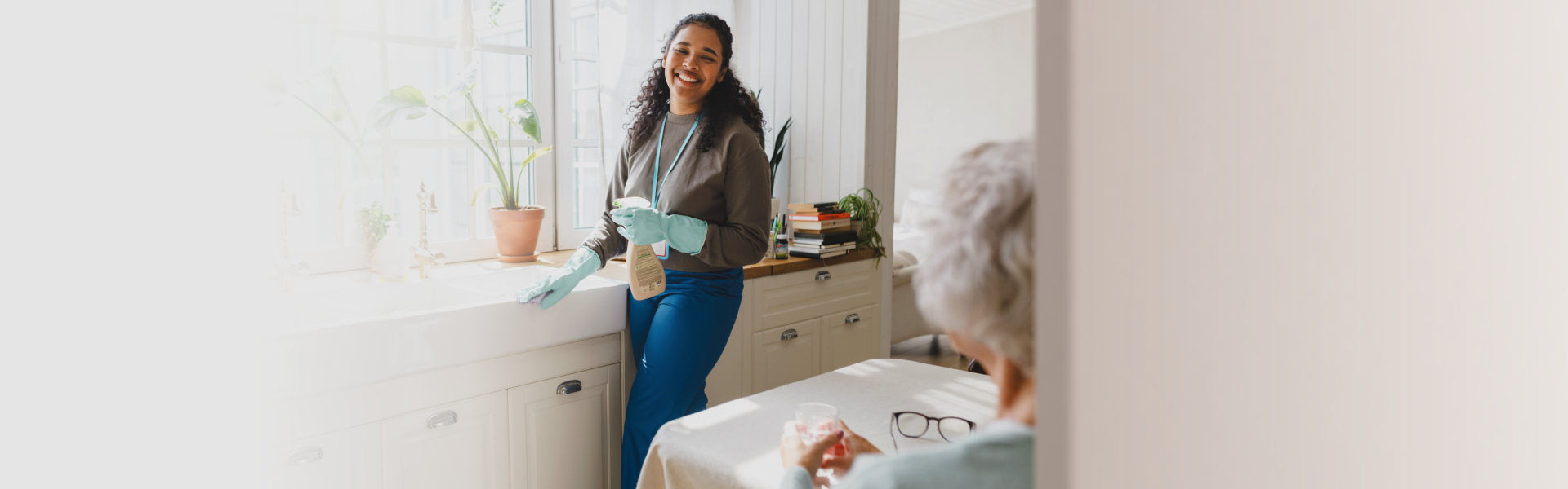 caregiver and senior woman looking outside the window